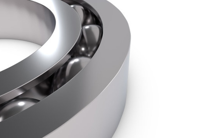How can you prevent grease from being flushed out of bearings?